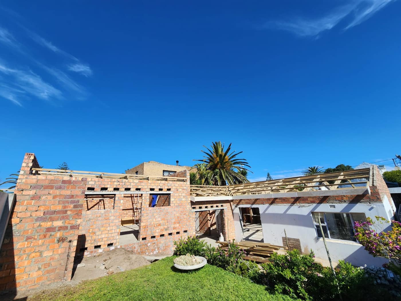 Timber roof trusses set and braced across the new structure