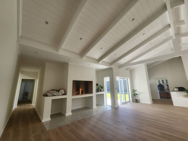 Renovated open-plan living area with a built-in fireplace